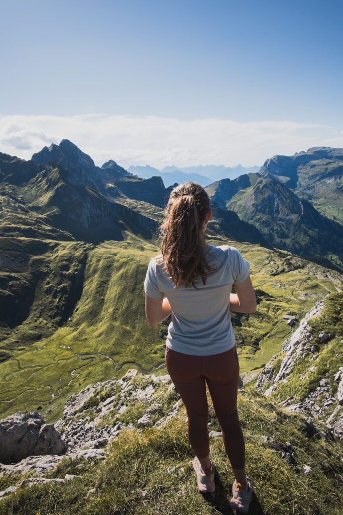 View from the Summit of Margelchopf with a hiking woman