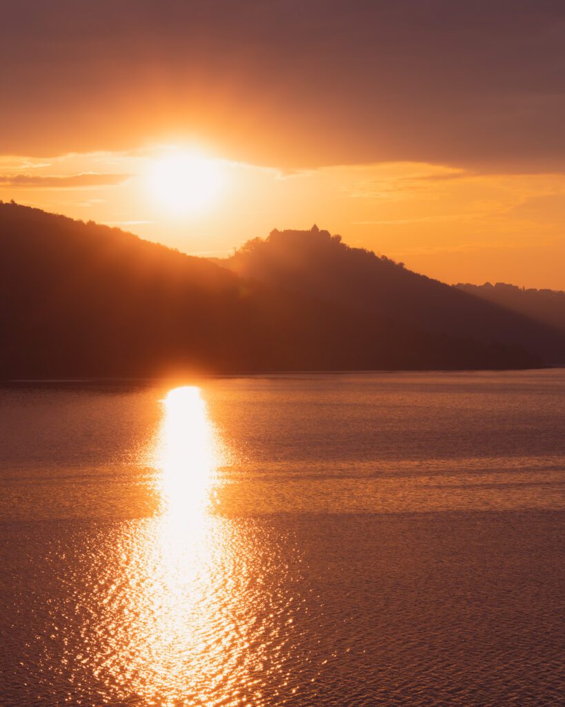 Sunrise at Kellerwald-Edersee showcasing silhouette of Walceck Castle