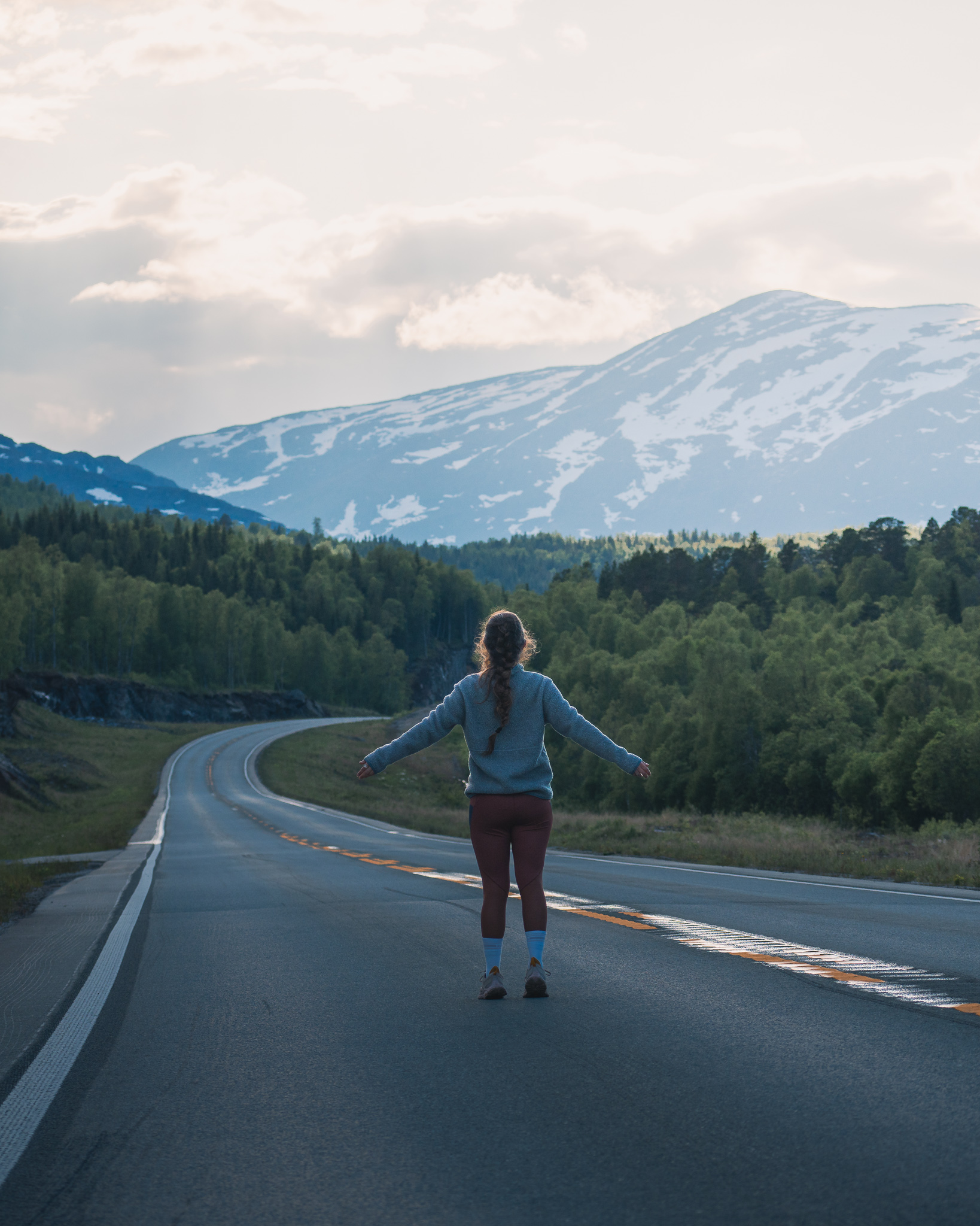 Alicia del Blog AliveandRoaming en medio de una carretera en un viaje en camper en Noruega